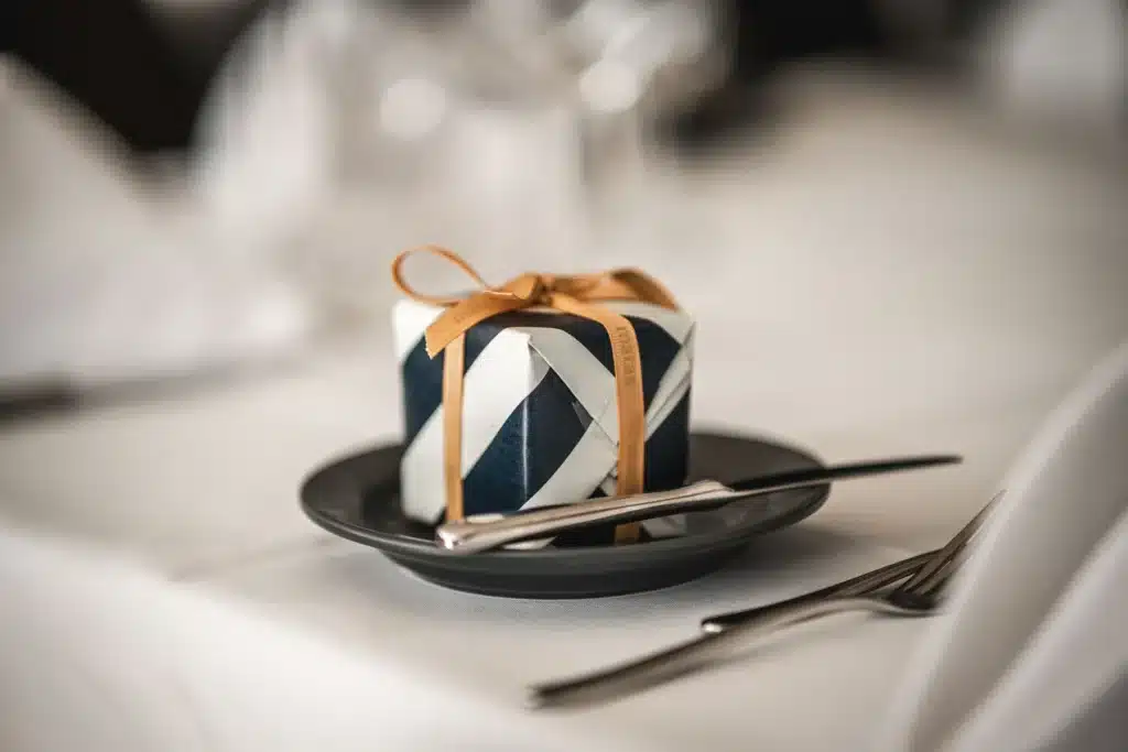 Table-setting details at a celebration A gift on a plate as part of the table setting at a celebration