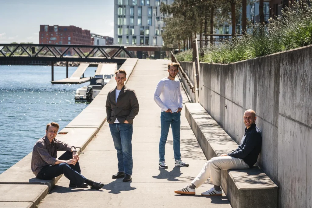 Four people by a canal for an outdoor group portrait