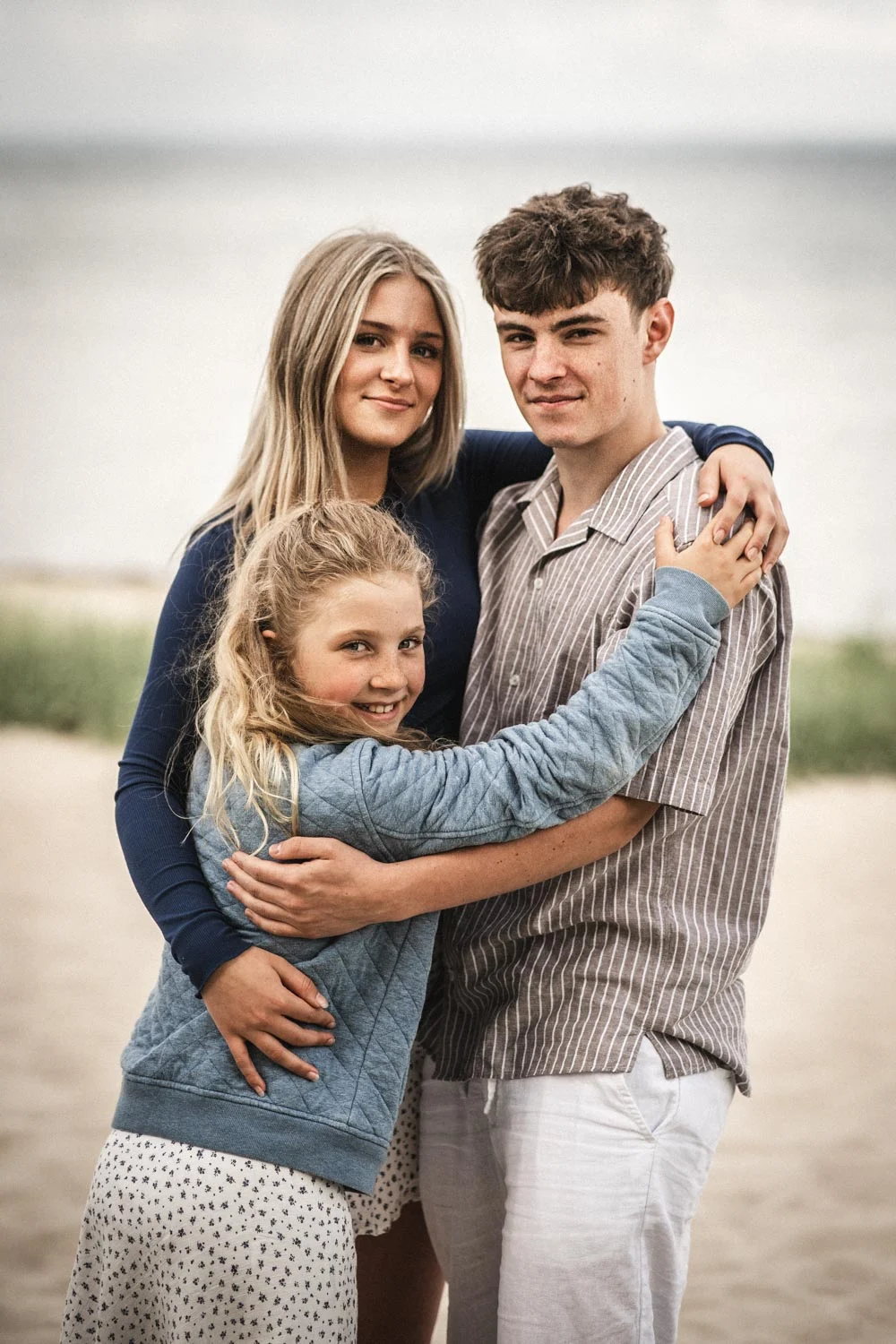 Family with two children together outdoors for a portrait