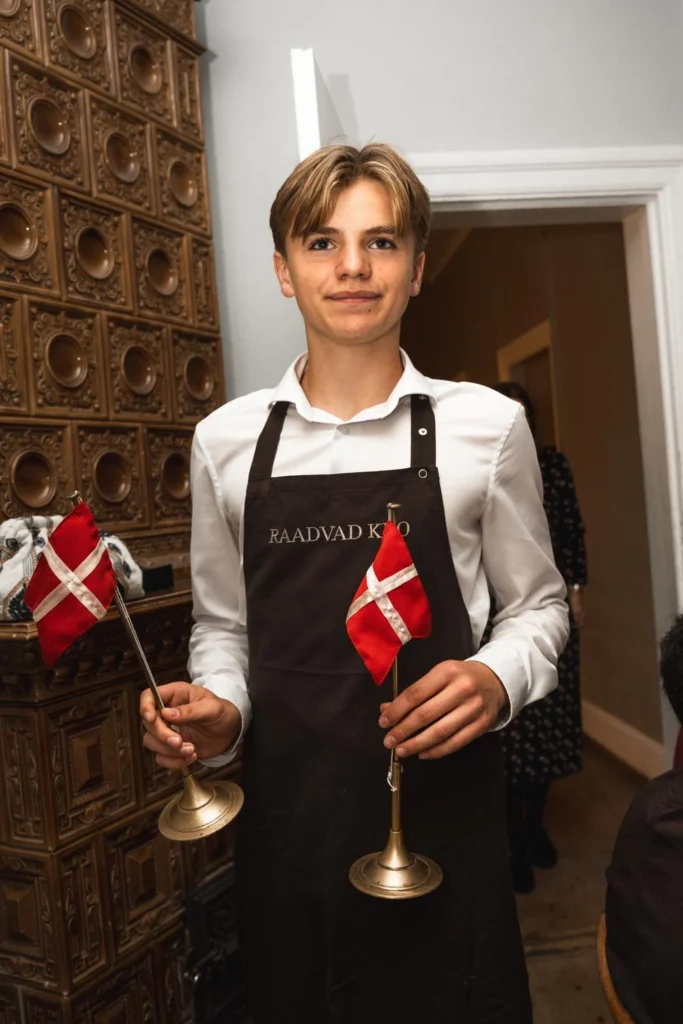 Server holding two Danish table flags at a private celebration Server holding two Danish table flags at a private celebration